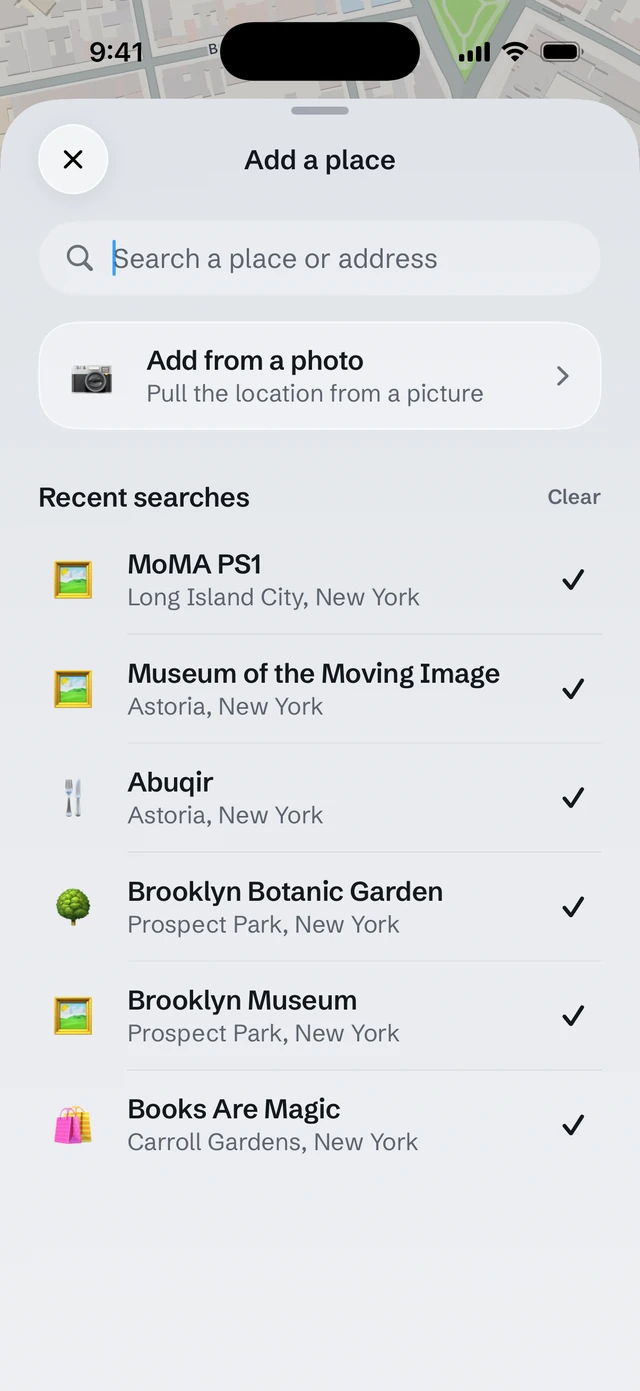 The Add a place sheet in Sauntered: search for a place or an address, or add one from a photo, over a list of recent searches.